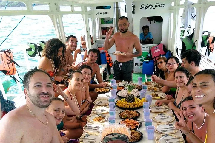 Travellers sharing a meal at a long table on board